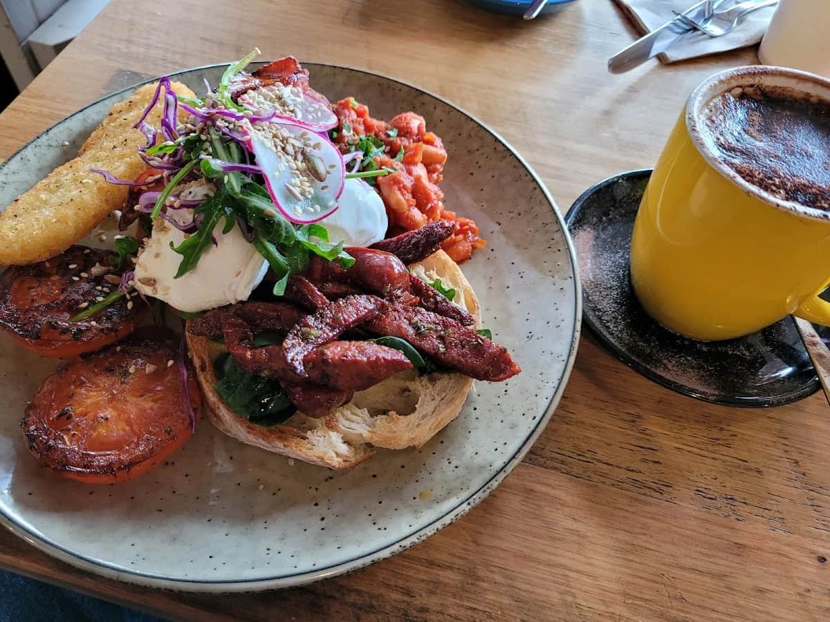 A colourful breakfast and fresh coffee on a timber table at 1923 Blackwood Cafe